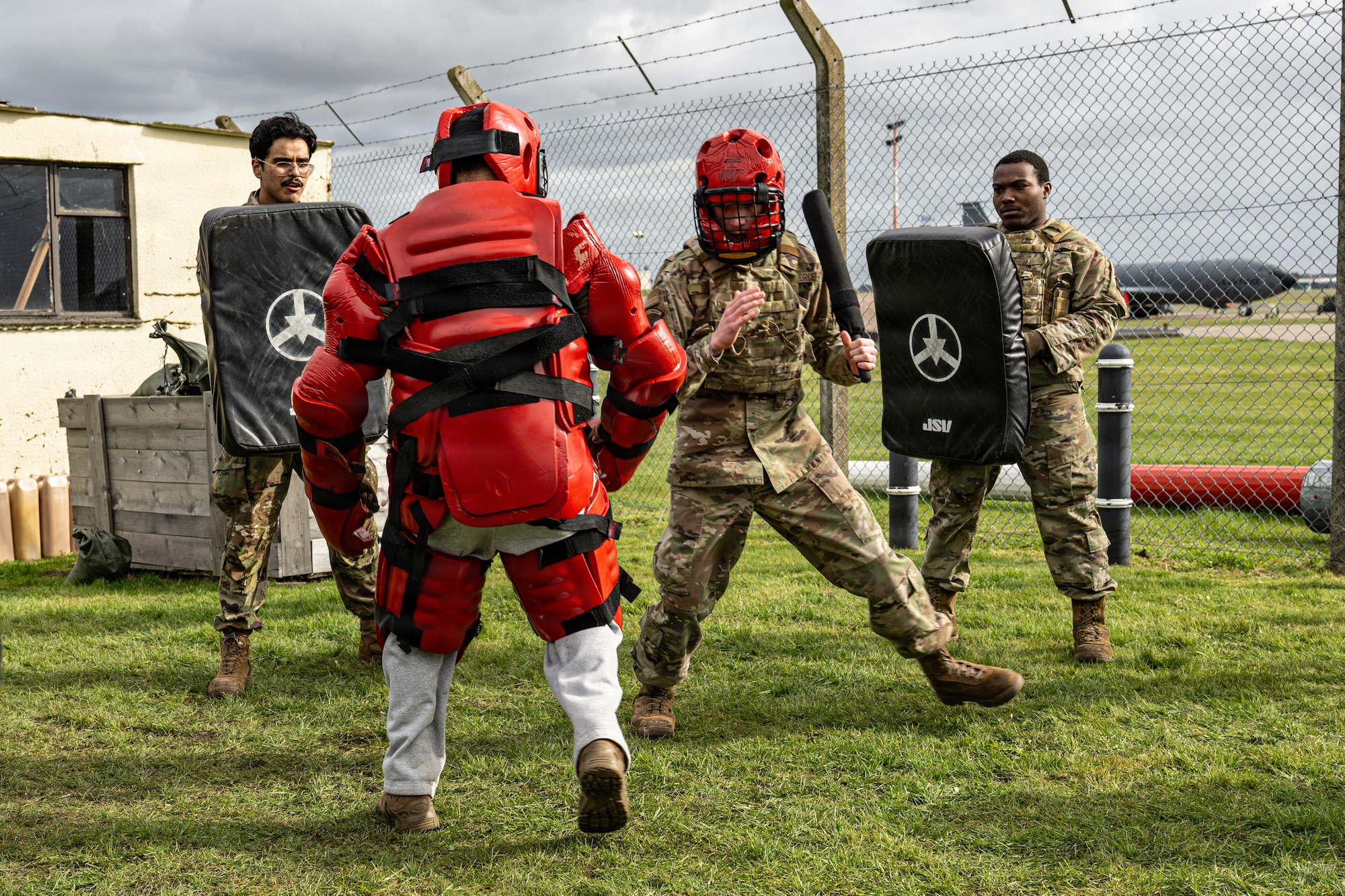 U.S. Air Force Airman 1st Class Jacob Barnes, second right, 100th Maintenance Squadron electrical and environmental systems journeyman, prepares to deliver a controlled baton strike during Redman defensive tactics training at RAF Mildenhall, England, March 16, 2026.