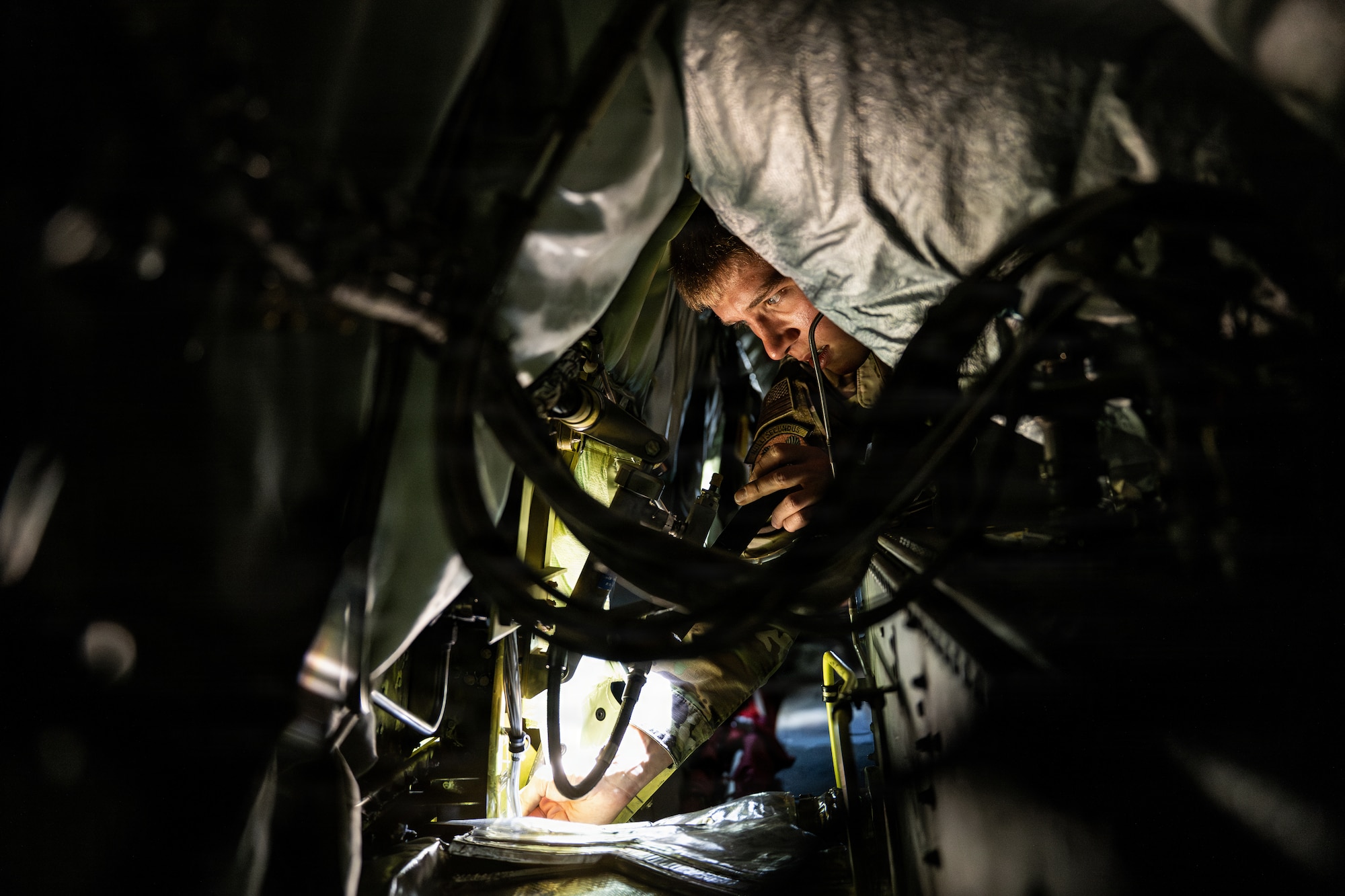 U.S. Air Force Airman 1st Class Jacob Barnes, 100th Maintenance Squadron electrical and environmental systems journeyman, troubleshoots a power unit in the engine of a 100th Air Refueling Wing KC-135 Stratotanker at RAF Mildenhall, England, April 13, 2026.