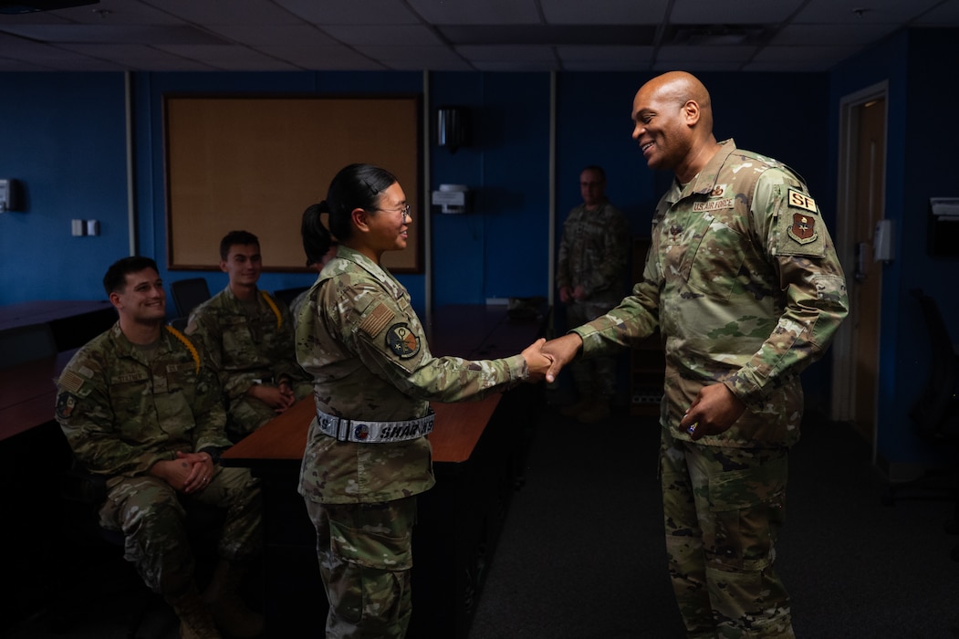 U.S. Air Force Maj. Gen. Roy W. Collins, Air Education Training Command deputy commander, coins Airmen student leaders inside the 316th Training Squadron dorms at Goodfellow Air Force Base, Texas, April 10, 2026. The 316th TRS is tasked with training, developing and inspiring the next generation of intelligence, surveillance and reconnaissance warriors. (U.S. Air Force photo by Senior Airman Brian Lummus)