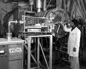 A U.S. Naval Research Laboratory technician operates a pulsed power experimental system in this archival image of the Gamble I, supporting early research into high-energy plasma behavior and laboratory simulation of space and fusion environments. The work contributed to foundational advances in plasma scence and national defense.