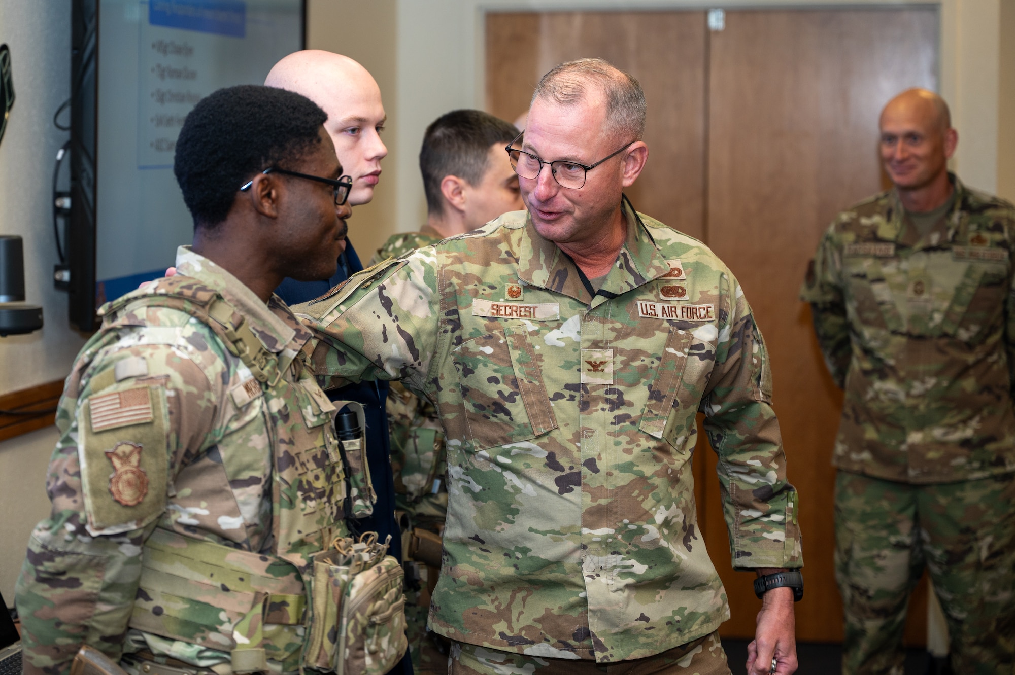 Col. Justin Secrest, 377th Air Base Wing and installation commander, coins Airman 1st Class Samuel Morrison in recognition of his swift response to a bomb threat that occurred on March 22 at the Eubank Gate at Kirtland Air Force Base, N. M., April, 14. Secrest and 377 ABW Command Chief Master Sgt. Secrest recognized Airmen for their swift actions, professionalism and commitment to base security during the incident. (U.S. Air Force photo by Senior Airman Donnell Schroeter)