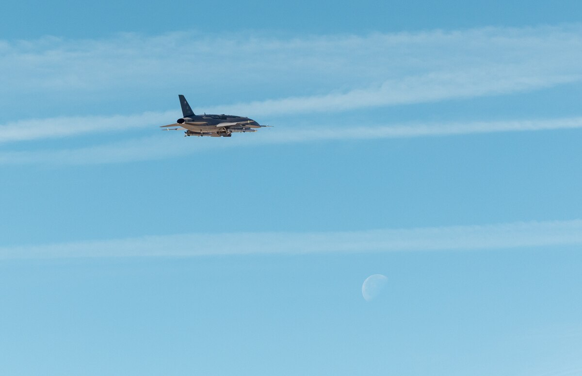 A YFQ-44A flies over Edwards Air Force Base, Calif., during a Collaborative Combat Aircraft exercise. Led by the Air Force’s Experimental Operations Unit under Air Combat Command, the effort emphasizes early operator-driven experimentation to develop tactics, techniques and procedures. (U.S. Air Force photo by Ariana Ortega)