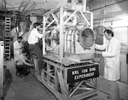 U.S. Naval Research Laboratory scientists work on the Ion Ring Experiment in this archival image of the Gamble II, a system used to study high-energy plasma behavior and confinement. The research contributed to advances in fusion science and high-energy density physics. (U.S. Navy photo)