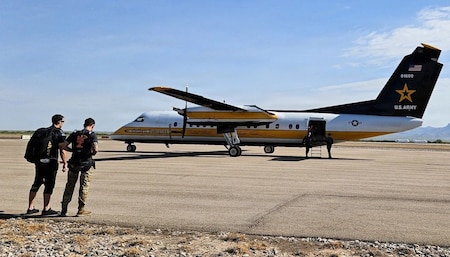 Two Golden Knights team members prepare for the day's tandem camp event.