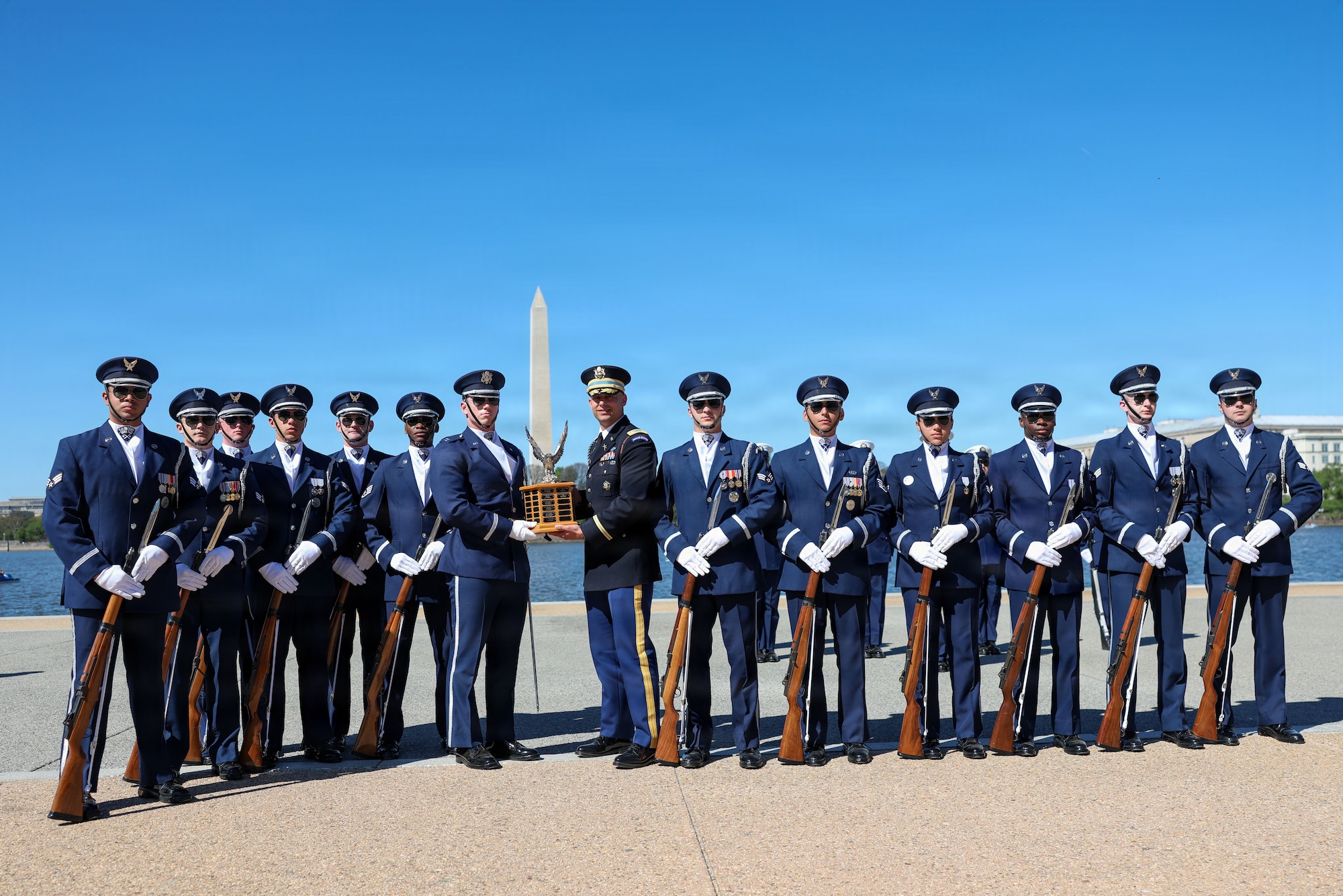 The U.S. Air Force Honor Guard Drill Team poses with the ceremonial trophy after winning the Joint Service Drill Exhibition at the Jefferson Memorial, Washington, D.C., April 11, 2026. Military drill teams from all U.S. military services performed while being evaluated on factors such as military bearing, precision, and crowd interaction. The U.S. Air Force Honor Guard Drill Team won the annual exhibition for the first time in 14 years. (U.S. Marine Corps photo by Cpl. Christopher Prelle)