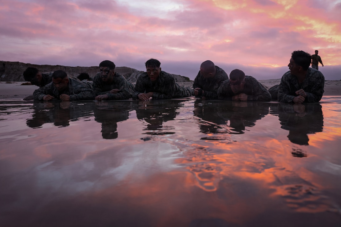 U.S. Marines perform low crawling techniques during a Marine Corps Martial Arts Instructor Course culminating event at Marine Corps Base Camp Pendleton, Calif., April 9, 2026. The MAIC provides the skills necessary to effectively teach and lead Marine Corps Martial Arts classes, including advanced Marine Corps Martial Arts Program techniques, teaching methodologies, leadership training and safety protocols. (U.S. Marine Corps photo by Cpl. Jacqueline Akamelu)