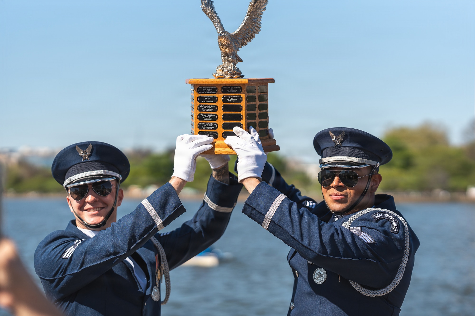 Senior Airmen Aaron Miles, left, and Wijeury Collado, right, U.S. Air Force Honor Guard ceremonial guardsmen, hold the Joint Service Drill Exhibition trophy at the Jefferson Memorial in Washington, D.C., April 11, 2026. Military drill teams from all U.S. military services performed while being evaluated on factors such as military bearing, precision, and crowd interaction. The U.S. Air Force Honor Guard Drill Team won the annual exhibition for the first time in 14 years. (U.S. Air Force courtesy photo)