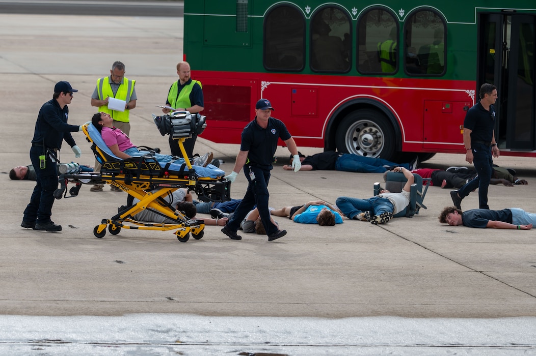 Emergency medical personnel transport a simulated casualty on a stretcher during a joint emergency response exercise at Mathis Field, San Angelo Regional Airport, San Angelo, Texas, April 15, 2026. Volunteers acted as victims to support a mass casualty scenario designed to improve interagency response and coordination. (U.S. Air Force photo by Senior Airman James Salellas)