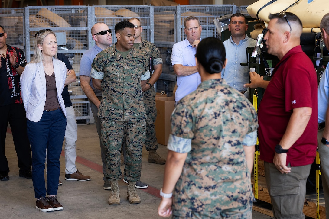 U.S. Marine Corps Brig. Gen. Maura Hennigan, commanding general of 2nd Marine Logistics Group, and Col. David Merles, commanding officer of Blount Island Command, listen as Gunnery Sgt. Maria Ingram, quality assurance chief, and Bobby Carter, engineer equipment manager, discuss equipment during a warehouse tour April 15 at Marine Corps Support Facility Blount Island, Florida. Dozens of senior logistics leaders from 2nd MLG participated in a conference hosted by Marine Corps Logistics Command, focused on strengthening a shared understanding of mission, structure, capabilities and innovation efforts while building relationships to enhance warfighter support. (U.S. Marine Corps photo by Dustin Senger)
