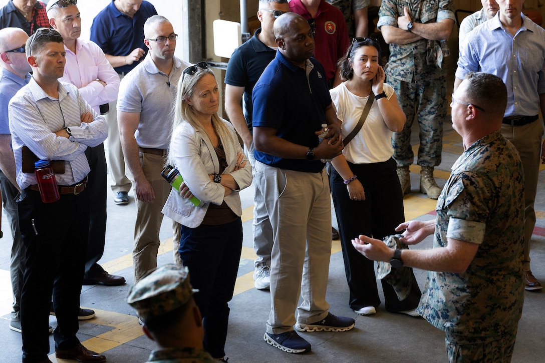 U.S. Marine Corps Brig. Gen. Maura Hennigan, commanding general of 2nd Marine Logistics Group, listens to Maj. James Fazica, material production director at Blount Island Command, discuss corrective and preventive procedures during a warehouse tour April 15 at Marine Corps Support Facility Blount Island, Florida. Dozens of senior logistics leaders from 2nd MLG participated in a conference hosted by Marine Corps Logistics Command, focused on strengthening a shared understanding of mission, structure, capabilities and innovation efforts while building relationships to enhance warfighter support. (U.S. Marine Corps photo by Dustin Senger)