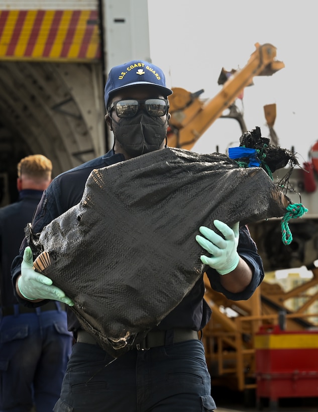 A Coast Guard Cutter Tampa (WMEC 902) crewmember offloads interdicted narcotics at Coast Guard Base Miami Beach, Florida, April 16, 2026. The offload was a result of two interdictions in international waters of the Eastern Pacific Ocean. (U.S. Coast Guard photo by Petty Officer 3rd Class Reese Hindmarsh)