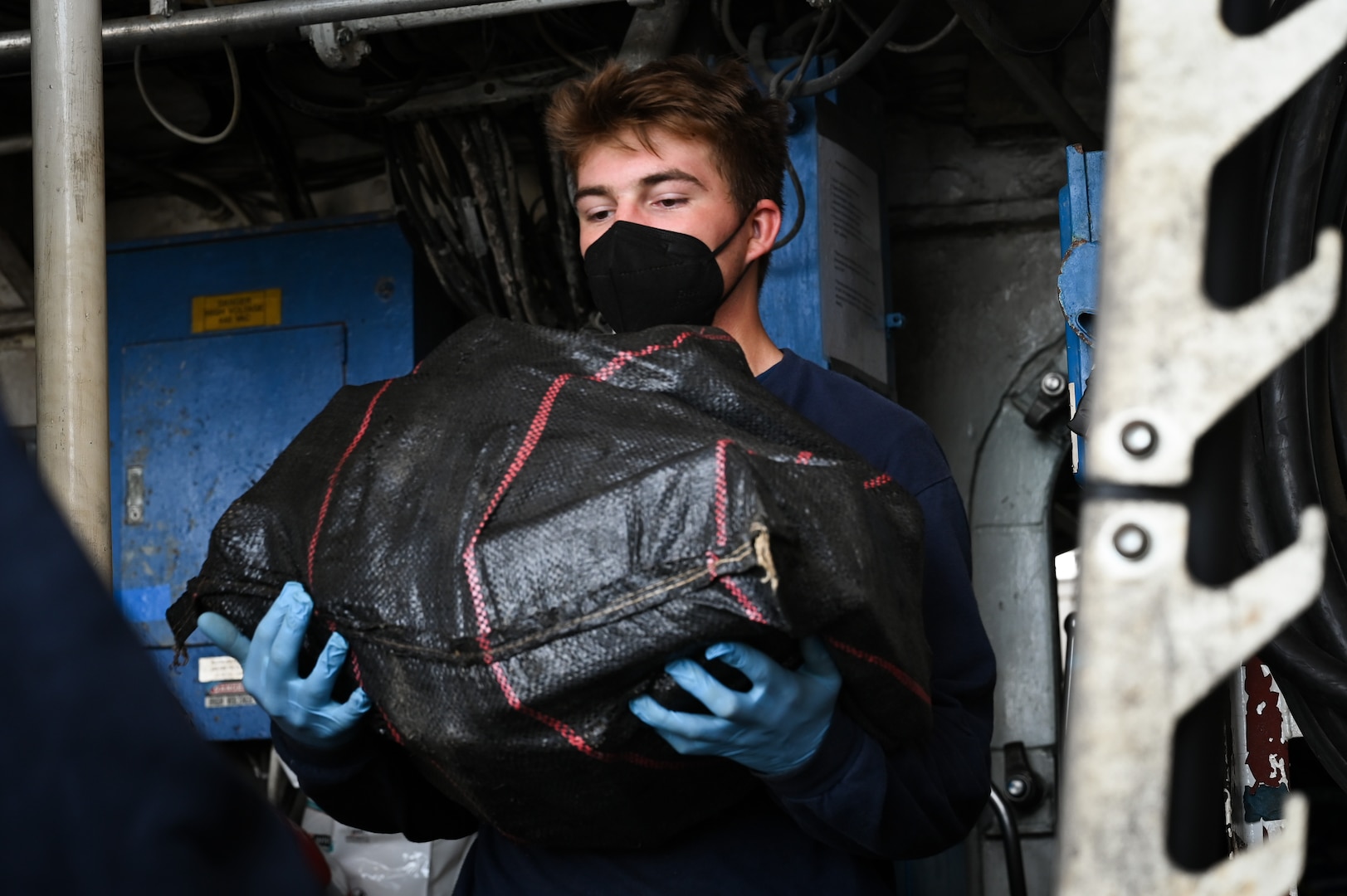 A Coast Guard Cutter Tampa (WMEC 902) crewmember offloads interdicted narcotics at Coast Guard Base Miami Beach, Florida, April 16, 2026. The offload resulted in more than 3,825 pounds of cocaine worth more than $28.7 million due to two interdictions in international waters of the Eastern Pacific Ocean (U.S. Coast Guard photo by Petty Officer 3rd Class Reese Hindmarsh)