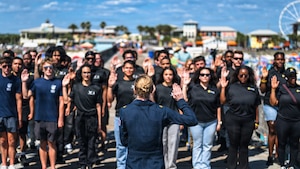 Maj. Megan Berberich, Thunderbird 9/Flight Surgeon assigned to the U.S. Air Force Air Demonstration Squadron “Thunderbirds,” recites the oath of enlistment to future service members during the Gulf Coast Salute Air Show at Panama City Beach, Fla., April 11, 2026. The Thunderbirds represent the professionalism and precision of the U.S. Air Force while showcasing unrivaled aerial capabilities. (U.S. Air Force photo by Senior Airman Zeeshan Naeem)
