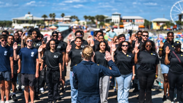 Maj. Megan Berberich, Thunderbird 9/Flight Surgeon assigned to the U.S. Air Force Air Demonstration Squadron “Thunderbirds,” recites the oath of enlistment to future service members during the Gulf Coast Salute Air Show at Panama City Beach, Fla., April 11, 2026. The Thunderbirds represent the professionalism and precision of the U.S. Air Force while showcasing unrivaled aerial capabilities. (U.S. Air Force photo by Senior Airman Zeeshan Naeem)
