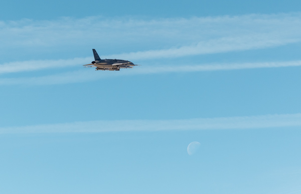 A YFQ-44A flies over Edwards Air Force Base, Calif., during a Collaborative Combat Aircraft exercise. Led by the Air Force’s Experimental Operations Unit under Air Combat Command, the effort emphasizes early operator-driven experimentation to develop tactics, techniques and procedures. (U.S. Air Force photo by Ariana Ortega)