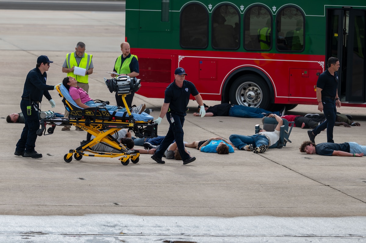 Emergency medical personnel transport a simulated casualty on a stretcher during a joint emergency response exercise at Mathis Field, San Angelo Regional Airport, San Angelo, Texas, April 15, 2026. Volunteers acted as victims to support a mass casualty scenario designed to improve interagency response and coordination. (U.S. Air Force photo by Senior Airman James Salellas)