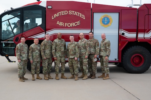 U.S. Air Force Maj. Gen. Roy W. Collins, Air Education Training Command deputy commander, poses for a group photo with 17th Training Wing leadership in front of a Rosenbauer Panther fire truck at the Louis F. Garland Department of War Fire Academy, Goodfellow AFB, Texas, April 10, 2026. The DoW Fire Academy trains joint-service members and allies in fire protection capabilities. (U.S. Air Force photo by Senior Airman Brian Lummus)