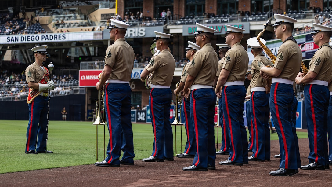 U.S. Marines with Marine Band San Diego, Marine Corps Recruit Depot San Diego, Western Recruiting Region stand at ease prior to performing at Petco Park, San Diego, California, April 12, 2026. U.S. Marines from MCRD San Diego were invited to the San Diego Padres Military Appreciation game to honor and show appreciation for the nation’s active-duty service members and veterans. (U.S. Marine Corps photo illustration by Lance Cpl. Kevin Alonso)