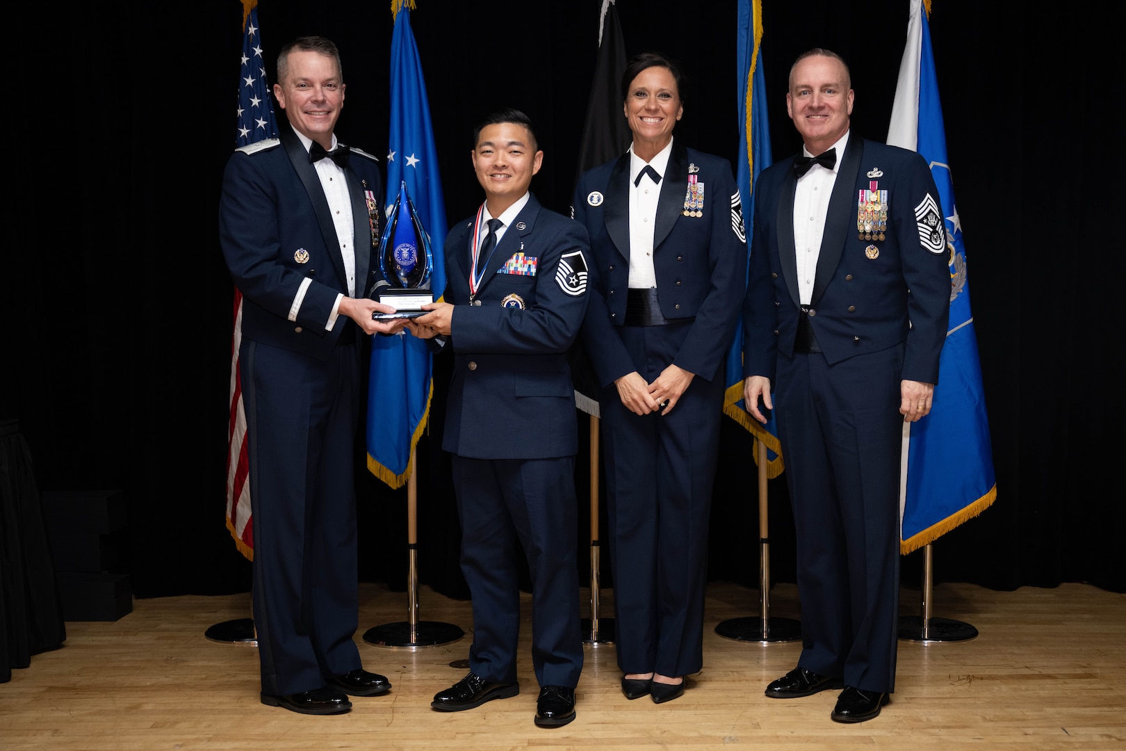 Chief Master Sgt. of the Air Force David Wolfe, right, Brig. Gen. Jeffrey W. Nelson, Air Force Accessions Center and Air Force Recruiting Service commander, left, and Command Chief Master Sgt. Karen “Liz” Fetherston,, Air Force Accessions Center and Air Force Recruiting Service, second from right, pose for a photo with the A.J. Stewart award winner during the Operation Blue Suit Award Banquet at the Parr Club on Joint Base San Antonio-Randolph, Texas, April 2, 2026. Master Sgt. Shaun Kho received the additional award, named after U.S. Air Force Major General Alfred J. Stewart, a former AFRS commander who “epitomized the recruiting spirit,” for being the Top Recruiter for fiscal year 2025. (U.S. Air Force photo by A1C Kevin Jones)