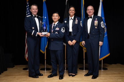 Chief Master Sgt. of the Air Force David Wolfe, right, Brig. Gen. Jeffrey W. Nelson, Air Force Accessions Center and Air Force Recruiting Service commander, left, and Command Chief Master Sgt. Karen “Liz” Fetherston,, Air Force Accessions Center and Air Force Recruiting Service, second from right, pose for a photo with the A.J. Stewart award winner during the Operation Blue Suit Award Banquet at the Parr Club on Joint Base San Antonio-Randolph, Texas, April 2, 2026. Master Sgt. Shaun Kho received the additional award, named after U.S. Air Force Major General Alfred J. Stewart, a former AFRS commander who “epitomized the recruiting spirit,” for being the Top Recruiter for fiscal year 2025. (U.S. Air Force photo by A1C Kevin Jones)