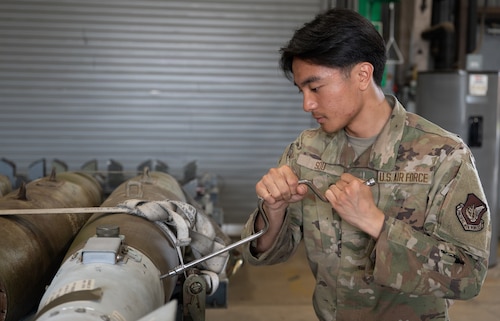 U.S. Air Force Airman Alexander Sou, 51st Munitions Squadron conventional maintenance technician, tightens bolts on munitions at Osan Air Base, Republic of Korea, April 14, 2026. Sou’s daily responsibilities include testing and maintaining munitions to utilize on F-16 Fighting Falcons.. (U.S. Air Force photo by Airman 1st Class Megan Cusmano)