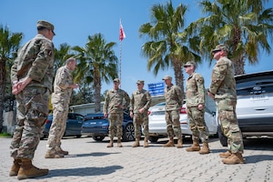 A group of service members standing in a circle