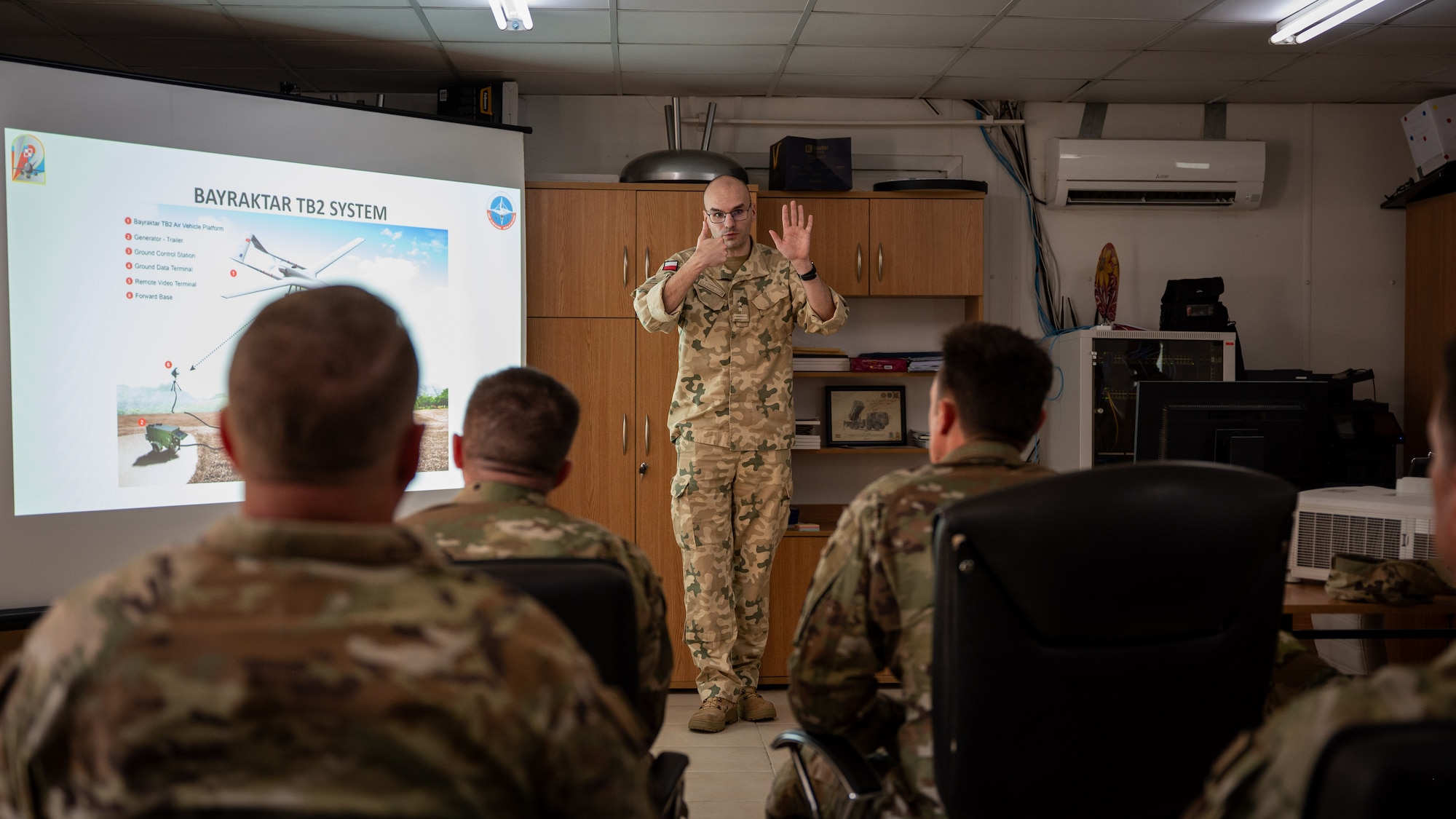 A Polish service member briefing a crowd