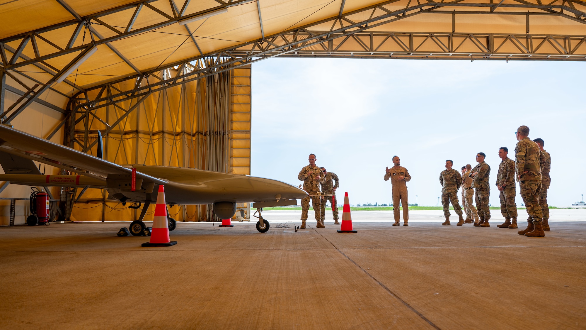 A group of service members viewing a drone