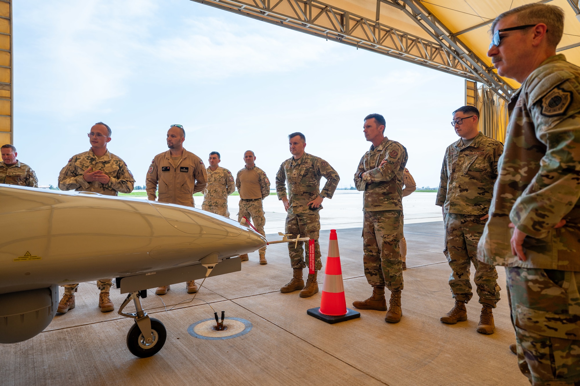 A group of service members viewing a drone