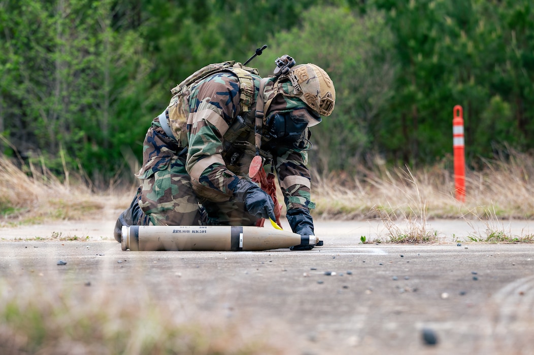 Airmen handling bomb