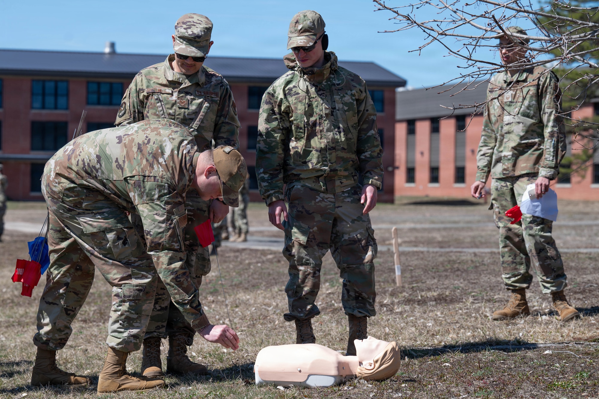 An airman places a flag down.