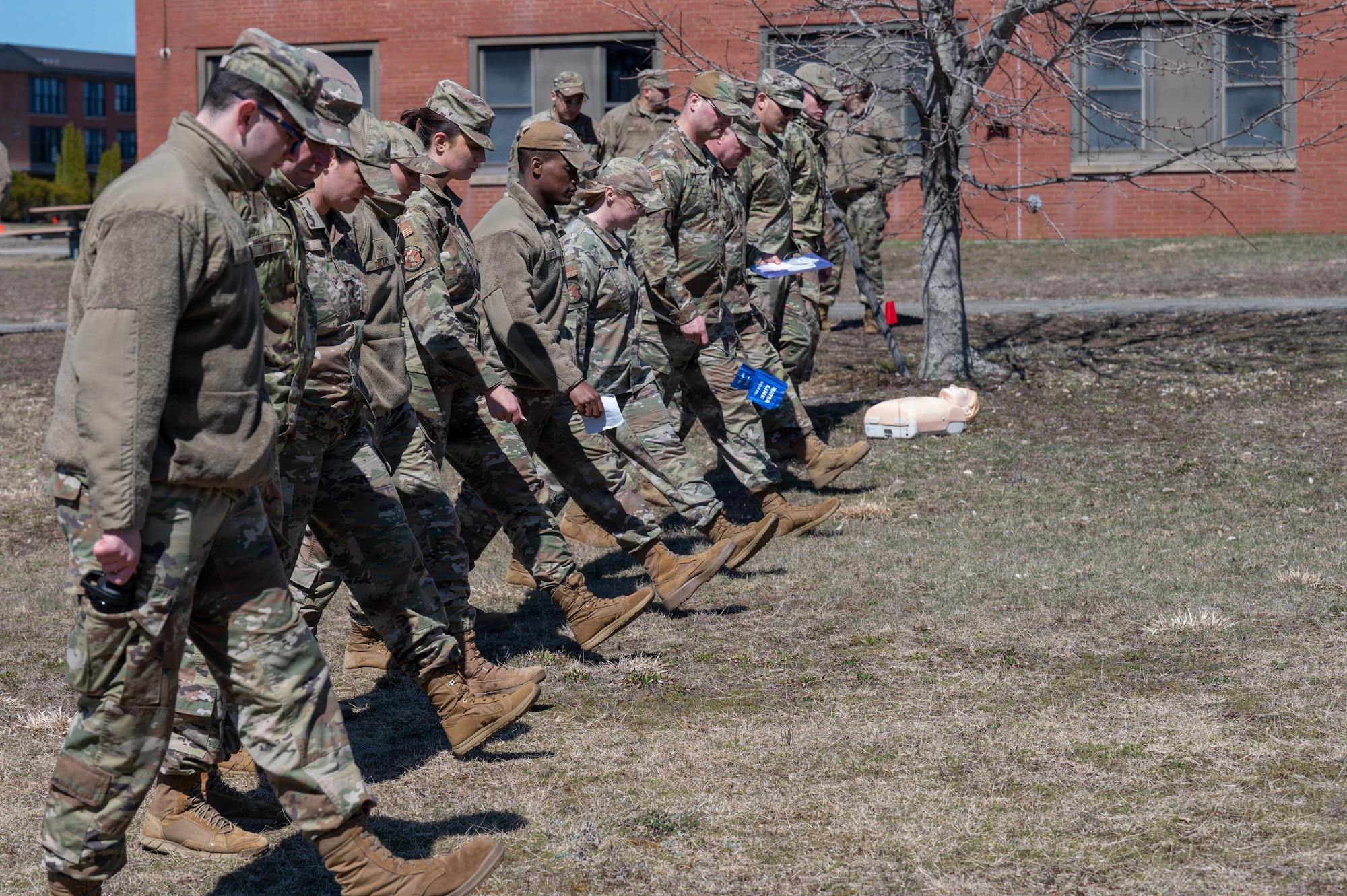 Airmen walk in a line.