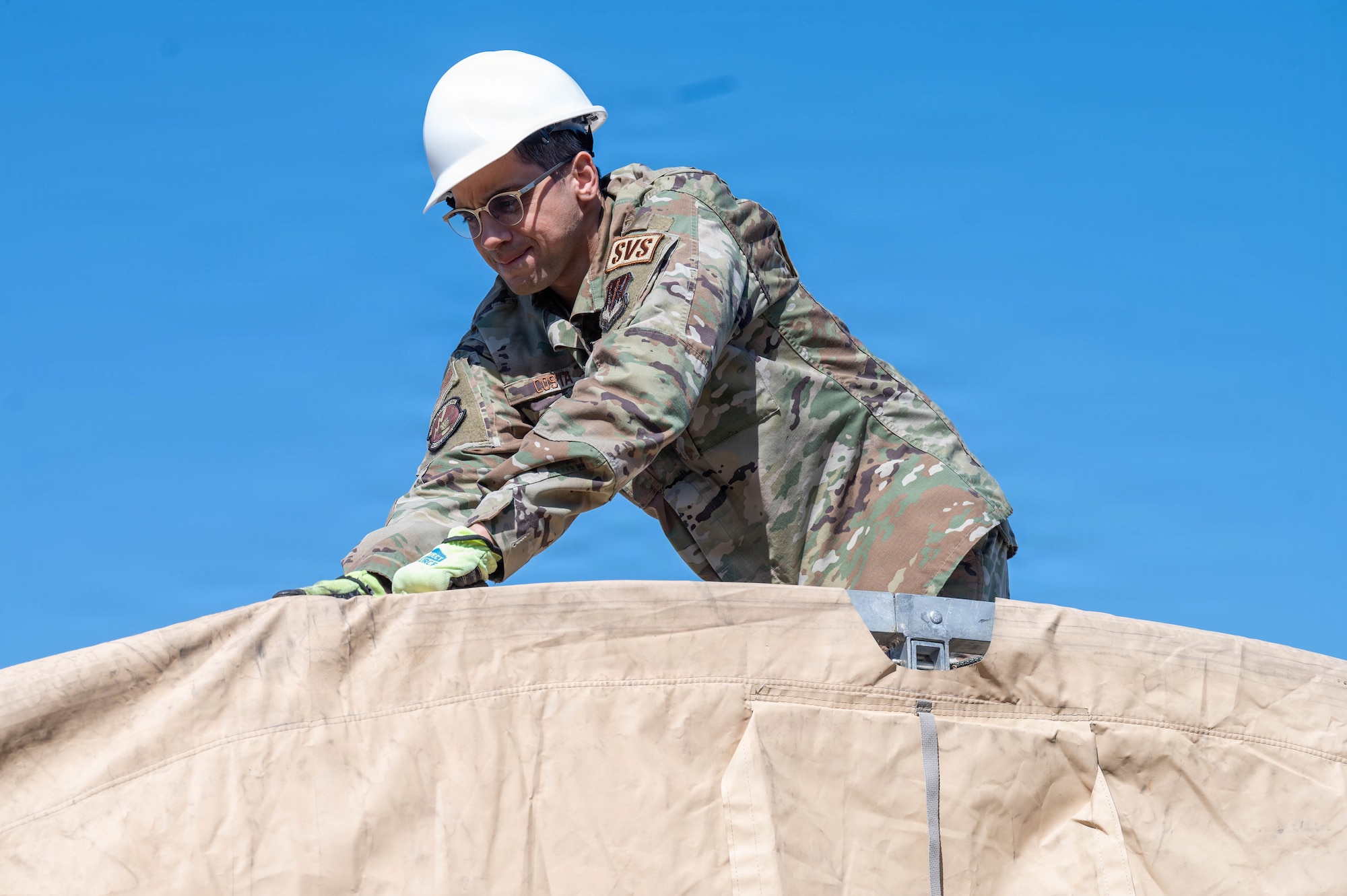 An airman builds a tent.