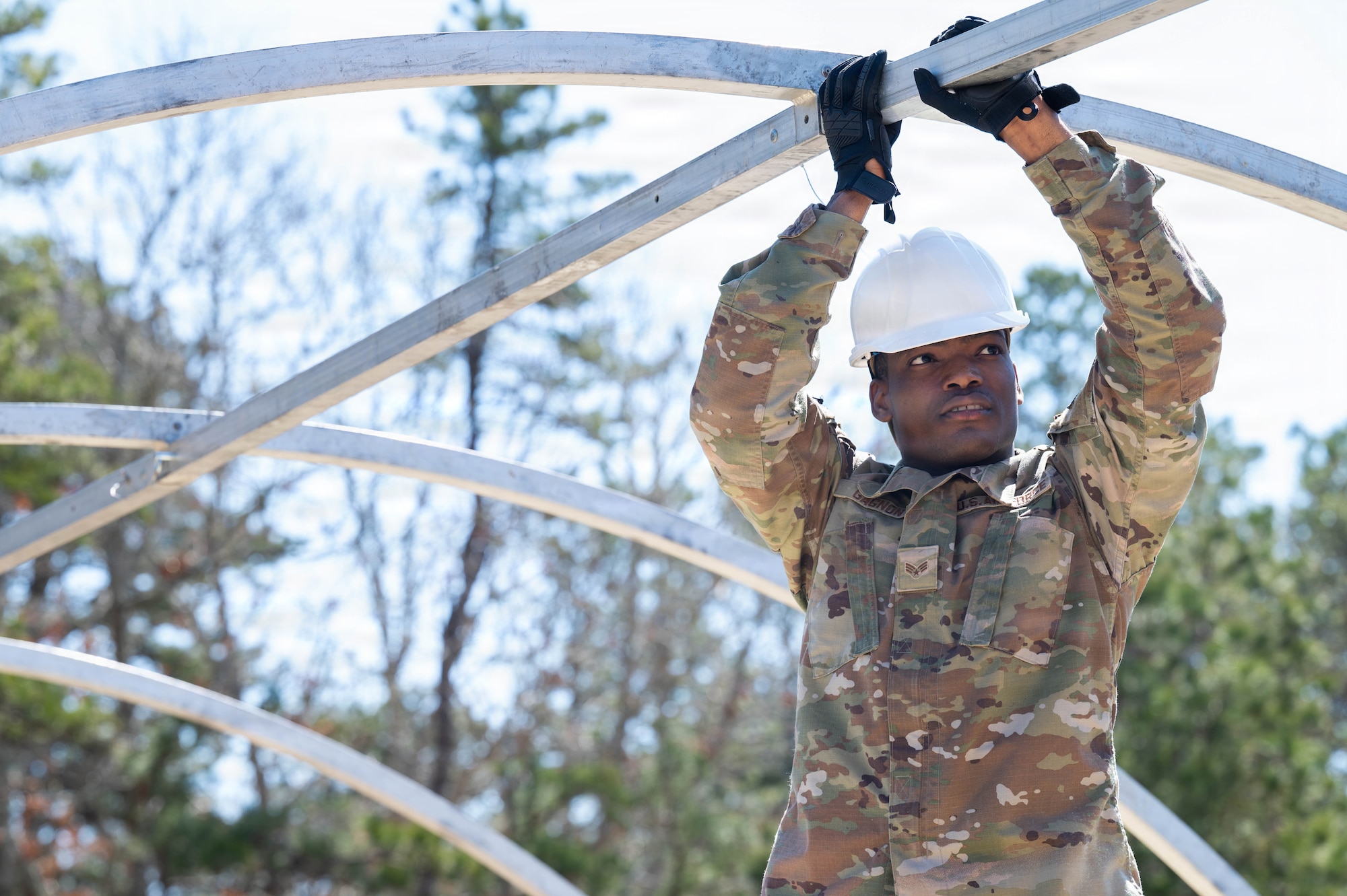 An airman builds a tent.