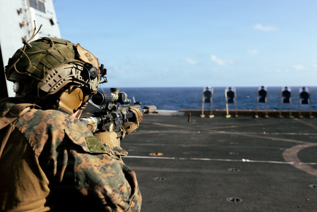 A U.S. Marine with Lima Company, Battalion Landing Team 3/6, 22nd Marine Expeditionary Unit (Special Operations Capable), engages a target during a deck shoot aboard San Antonio-class amphibious transport dock USS San Antonio (LPD 17) while underway in the Caribbean Sea, April 13, 2026. U.S. military forces are deployed to the Caribbean in support of the U.S. Southern Command mission, Department of War-directed operations, and the president’s priorities to disrupt illicit drug trafficking and protect the homeland. (U.S. Marine Corps photo)