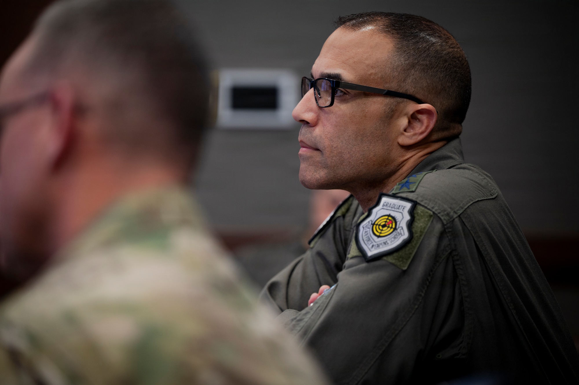 U.S. Air Force Gen. Adrian Spain, commander of Air Combat Command, receives a brief regarding a new Artificial Intelligence tool developed by Airmen at the 20th Fighter Wing, Joint Base Langley-Eustis, Virginia, March 24, 2026. This new weather data analysis tool, which has expedited operations by more than eighty-five hours a month, is one of many advanced machine learning tools created under the ACC Operations Directorate’s AI division. (U.S. Air Force photo by Staff Sgt. Michael Bowman)
