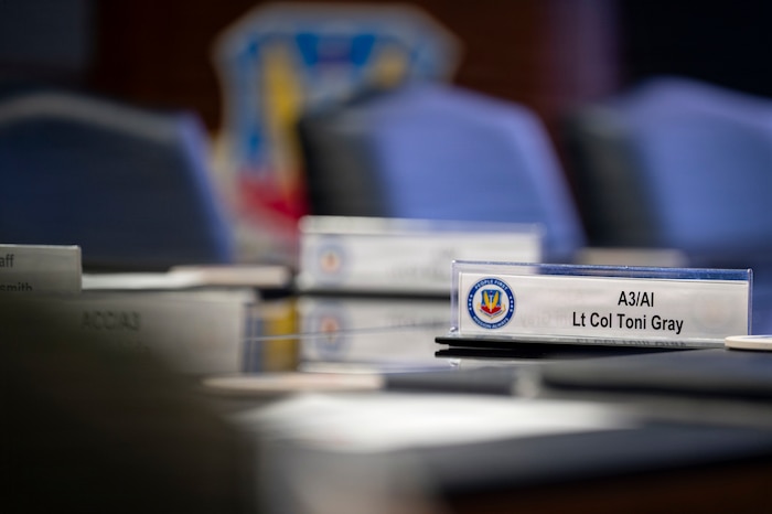 A nameplate sits static during a brief, Joint Base Langley-Eustis, Virginia, March 24, 2026. U.S. Air Force Lt. Col. Toni Gray serves as the Air Combat Command A3 director of AI strategy and implementation. (U.S. Air Force photo by Staff Sgt. Michael Bowman)
