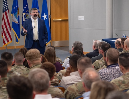 Image of a man addressing an audience.