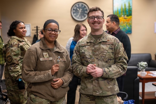 U.S. Air Force Staff Sgt. Saivonna Francis, assigned to the 673d Communications Squadron, left, and Staff Sgt. Brady Nelson, assigned to the 3rd Maintenance Group, take a photo together during the 3rd Annual Sexual Assault Prevention and Response Open House on Joint Base Elmendorf-Richardson, Alaska, April 2, 2026. Both Airmen were recognized by U.S. Army Col. Stephen Polacek, deputy commander of the 673d Air Base Wing, for dedicating more than 4,000 hours as SAPR volunteer victim advocates. Tasks assigned to SAPR volunteer victim advocates include 24/7 on-call emotional support and crisis intervention, coordination with agencies to ensure a victim's safety and providing information and resources to military personnel and civilians. (U.S. Air Force photo by Airman 1st Class Eli Rose)