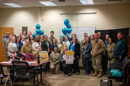 Military personnel and civilians gather for a photo during the 3rd Annual Sexual Assault Prevention and Response Open House on Joint Base Elmendorf-Richardson, Alaska, April 2, 2026. The open house gathered military and civilian workers across the installation to talk about the SAPR program and resources it offers JBER personnel. Programs like SAPR and the U.S. Army's Sexual Harassment/Assault Response and Prevention, or SHARP, are known to play a vital role where they address and combat sexual violence within the military community across all installations. (U.S. Air Force photo by Airman 1st Class Eli Rose)