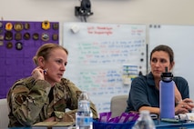 A photo of base leadership discussing innovation ideas.