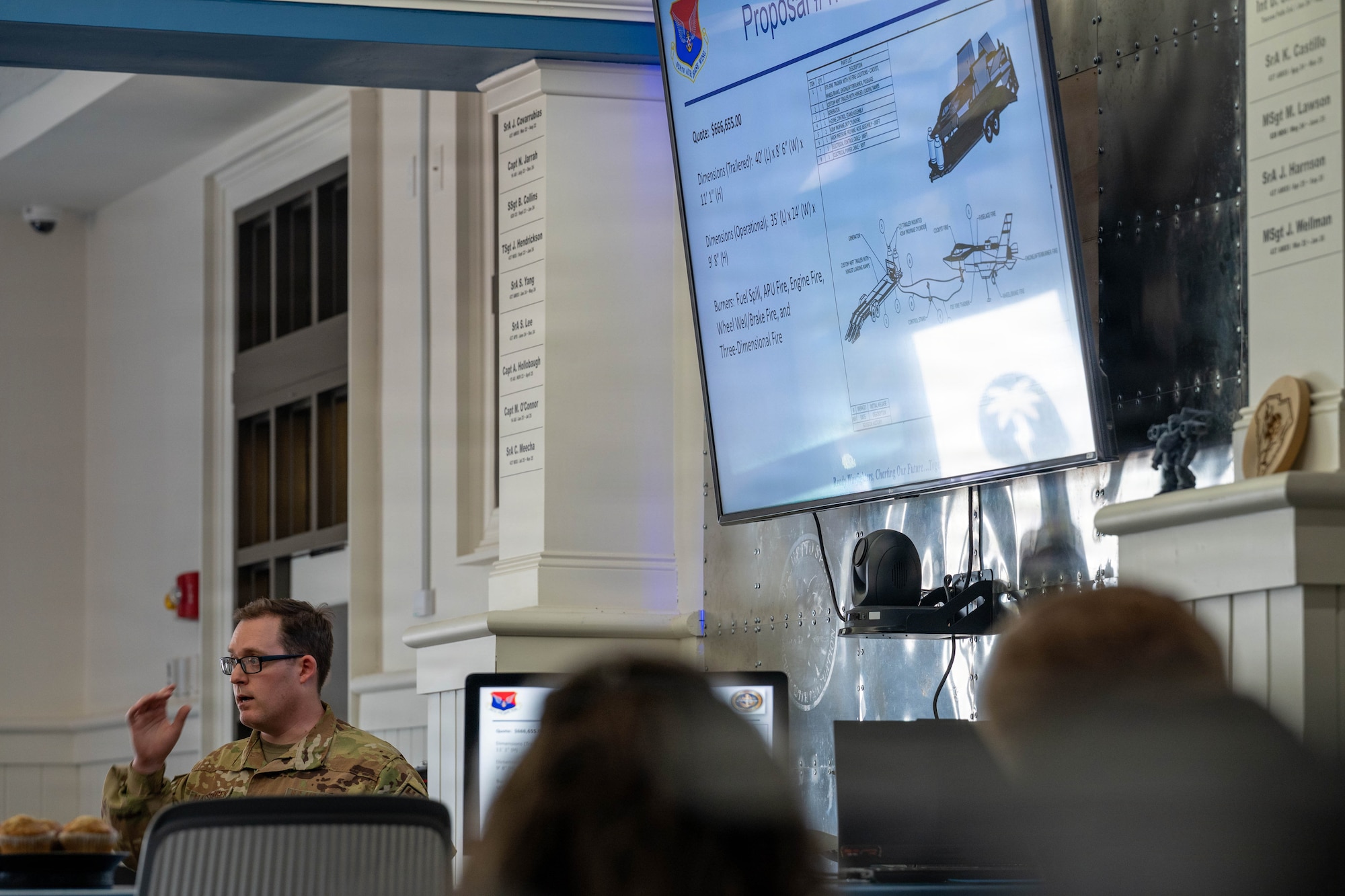 A photo of a man giving a presentation to base leadership.