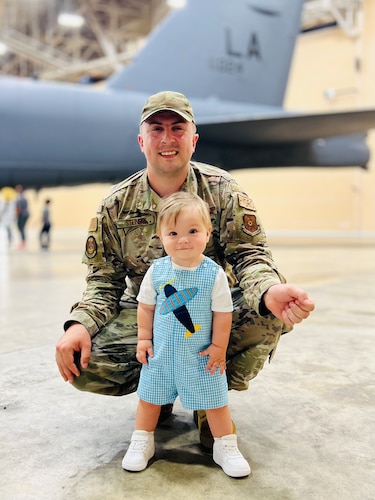 Tech. Sgt. Alec Steinert, 595th Aircraft Maintenance Squadron, takes a photo with his son, Remi, who was one year old at the time, while stationed at Barksdale Air Force Base, Louisiana, May 25, 2023. Remi developed a natural music ability to play drums.