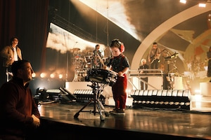 Remi, son of Tech. Sgt. Alec Steinert, 595th Aircraft Maintenance Squadron, and Jessica Steinert, military spouse, performs “The Little Drummer Boy” with the pop band, For King + Country, at the Grand Ole Opry in Nashville, Tennessee, Dec. 16, 2025. Remi was chosen to perform after winning a social media contest.
