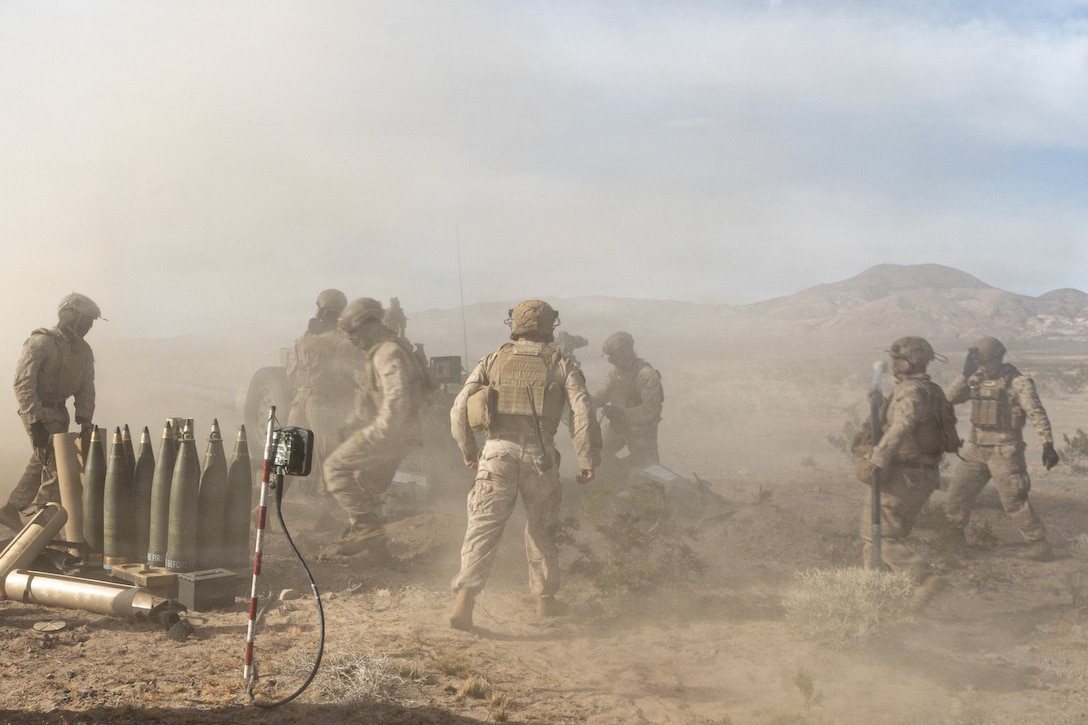 U.S. Marines with Kilo Battery, 3rd Battalion, 11th Marine Regiment, 1st Marine Division, conduct a direct fire field artillery mission, during a battery movement to contact exercise at Marine Corps Air Ground Combat Center, Twentynine Palms, California, March 6, 2026. The exercise allows Marines to conduct fire missions while continuously displacing to maintain the unit's survivability and culminating in the defense of the battery through direct fire engagements and crew-served weapons employment. (U.S. Marine Corps photo by Lance Cpl. Emilio Murphy)