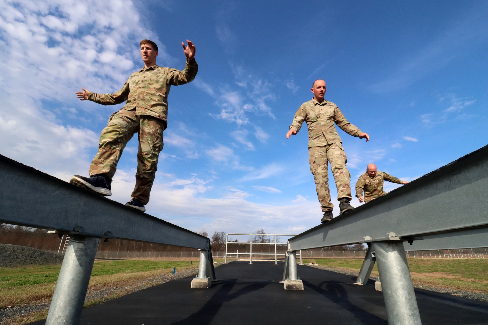 U.S. Army Reserve 1st Lt. David Grumhaus, left, military intelligence officer, Headquarters and Headquarters Company, 415th Civil Affairs Battalion; U.S. Army Reserve Staff Sgt. Christopher Rowe, center, cargo specialist, 489th Transportation Company; and U.S. Army Reserve Capt. David Petersen, deputy operations officers and joint operations center executive officer, Army Reserve Element European Command, negotiate the balance beams on the NATO obstacle course during the U.S. Army Reserve Command’s Interallied Confederation of Reserve Officers (CIOR) selection competition at Joint Base McGuire-Dix-Lakehurst, N.J., April 1, 2026. Grumhaus, Rowe and Petersen, were among seven officers and five noncommissioned officers selected from the competition, held March 30 - April 3, to represent the United States this summer in Europe at the 2026 CIOR Military Competition, where reserve forces from NATO nations will compete in challenges that test teamwork, endurance and combat skills. (U.S. Army photo by Steven Roussel)