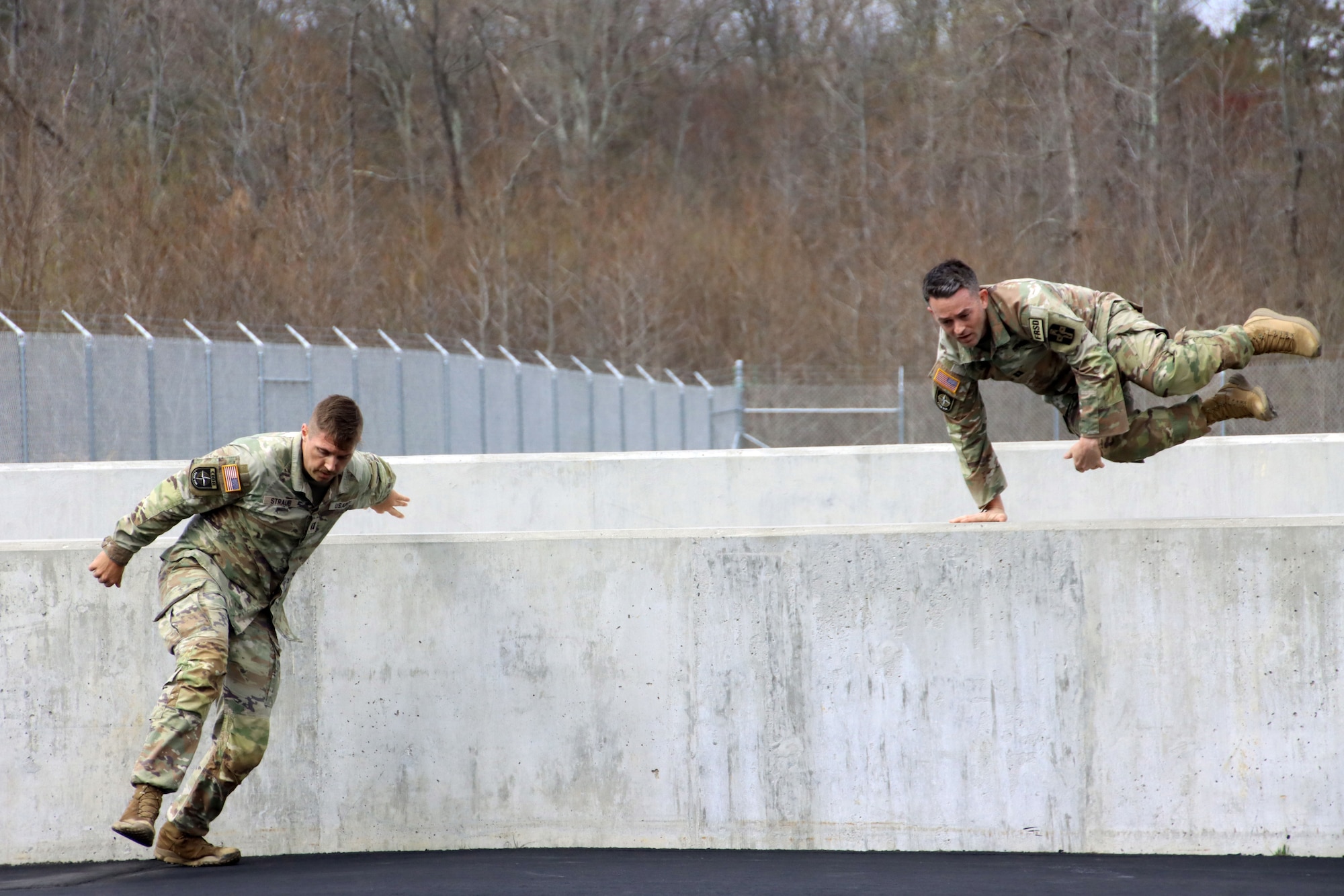 U.S. Army Reserve Capt. Jake Straub, left, commander, Greater Kansas City Army Recruiting Company, and U.S. Army Capt. Michael Vigh, critical care nurse, 628th Forward Resuscitative Surgical Detachment, jump assault walls on the NATO obstacle course during the U.S. Army Reserve Command’s Interallied Confederation of Reserve Officers (CIOR) selection competition at Joint Base McGuire-Dix-Lakehurst, N.J., April 1, 2026. Straub and Vigh were among seven officers and five noncommissioned officers selected from the competition, held March 30 - April 3, to represent the United States this summer in Europe at the 2026 CIOR Military Competition, where reserve forces from NATO nations will compete in challenges that test teamwork, endurance and combat skills. (U.S. Army photo by Steven Roussel)
