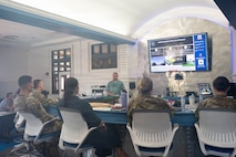 A photo of a man giving a presentation to base leadership.