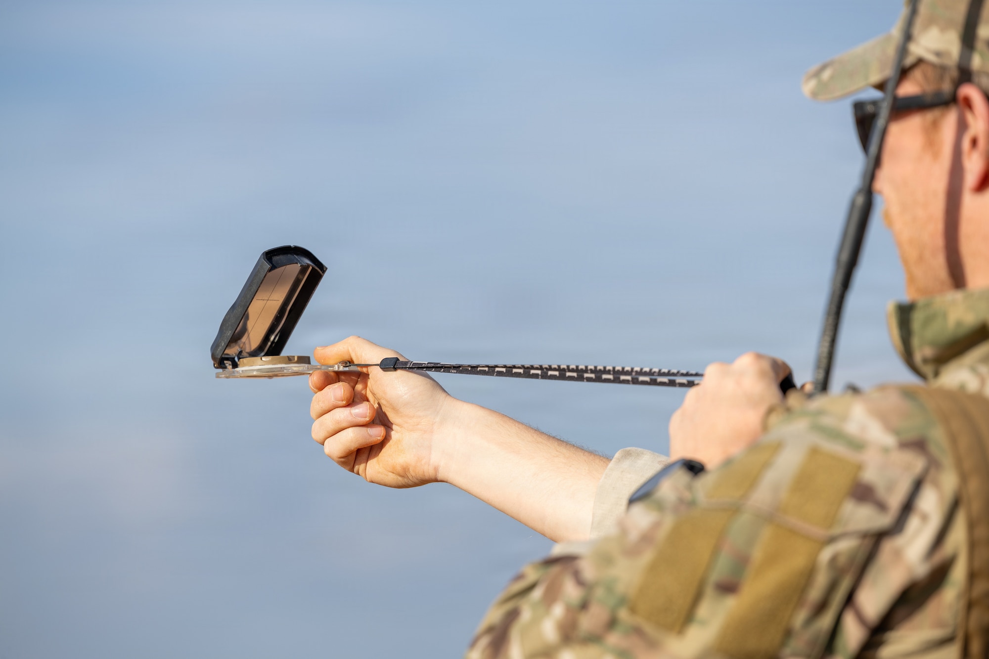 A Dutch pathfinder assigned to the 11th Air Assault Brigade, Royal Netherlands Army, uses a compass to help establish a landing zone during a Landing Zone Safety Officer course at Holland Drop Zone, Fort Bragg, N.C., March 5, 2026.