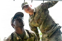 A photo of two Airmen repairing a C-47 Skytrain.